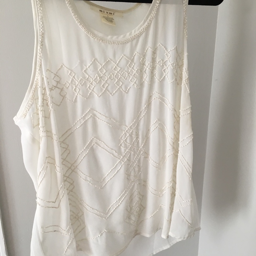 Shear sleeveless shirt with beading